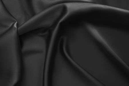 Black luxury wavy rippled glossy silk drapery cloth fabric. Abstract backgroundの写真素材