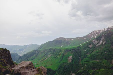 Mountains rocks landscape with cloudy dramatic sky. North nature background.