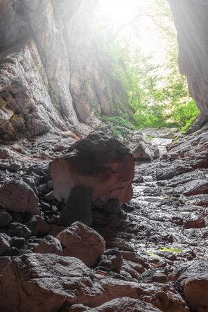 Stone cave inside view. Light exit from dark underground. Speleology or geology conceptの写真素材
