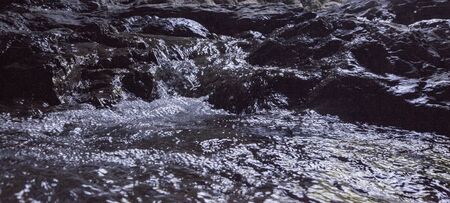 Creek river water flowing on stones. Freshness concept. Nature backgroundの写真素材