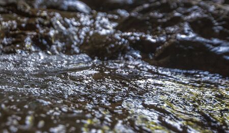 Creek river water flowing on stones. Freshness concept. Nature backgroundの写真素材
