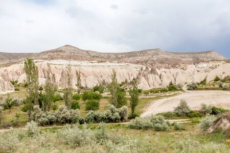 Beautiful mountains rocks landscape. Cloudy sky. Cappadocia, Nevsehir Province, Anatolia Region of Turkeyの写真素材