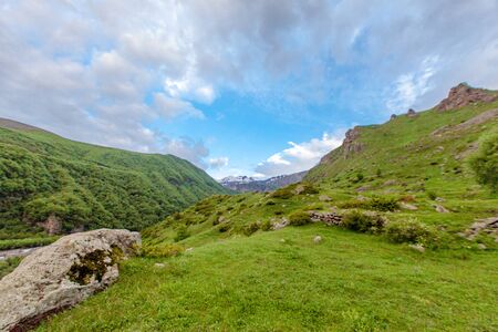 Mountains rocks landscape with cloudy dramatic sky. North nature background.