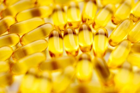 Fish oil capsules pills heap. Medicine backgroundの写真素材