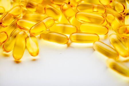 Fish oil capsules pills heap. Medicine background