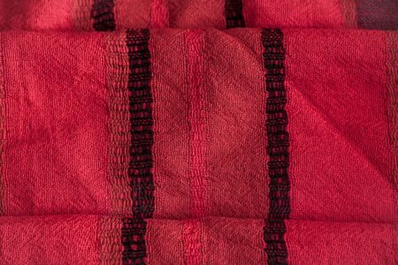 Red woolen fabric cloth background. Wavy texture purple materialの写真素材