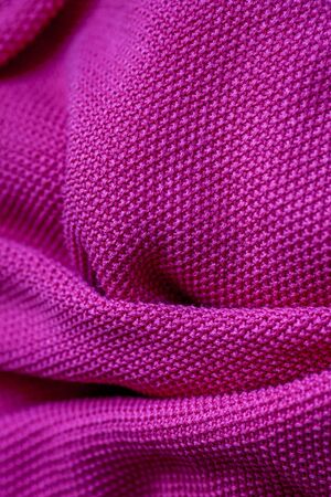 Pink woolen fabric cloth background. Wavy texture purple materialの写真素材
