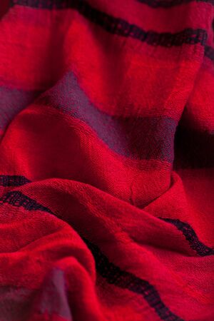 Red woolen fabric cloth background. Wavy texture purple materialの写真素材