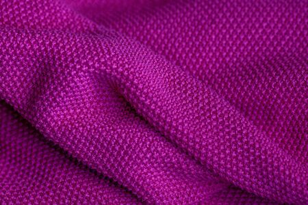 Pink woolen fabric cloth background. Wavy texture purple materialの写真素材