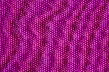 Pink woolen fabric cloth background. Wavy texture purple materialの写真素材