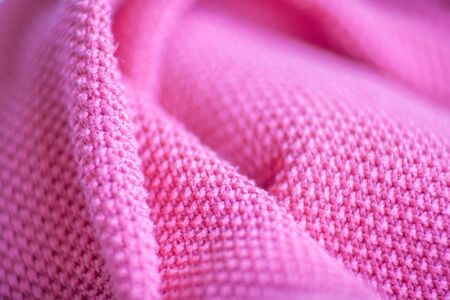Pink woolen fabric cloth background. Wavy texture purple materialの写真素材