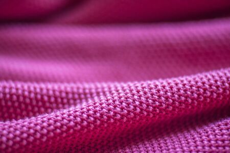 Pink woolen fabric cloth background. Wavy texture purple materialの写真素材