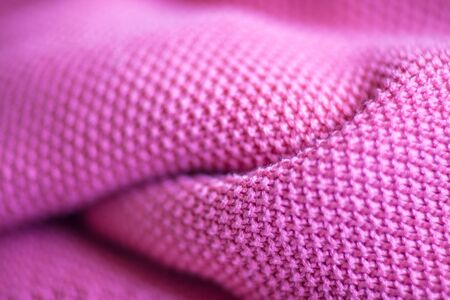 Pink woolen fabric cloth background. Wavy texture purple materialの写真素材