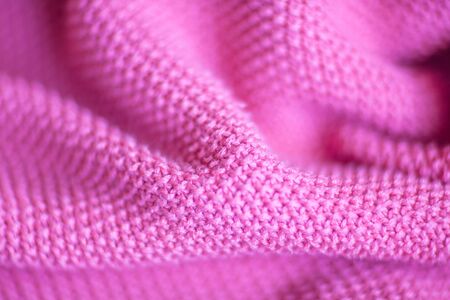 Pink woolen fabric cloth background. Wavy texture purple materialの写真素材