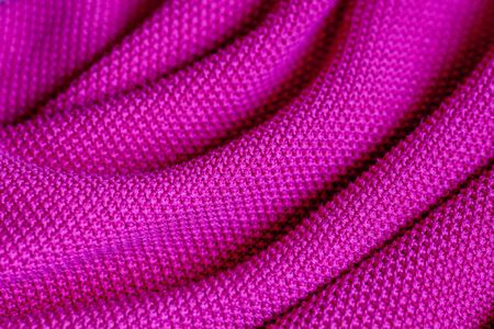 Pink woolen fabric cloth background. Wavy texture purple materialの写真素材