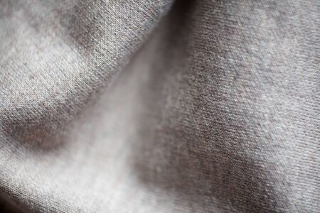 Wool fabric texture close up background. Cozy style cloth. Wavy folds materialの写真素材