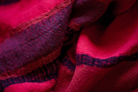 Red woolen fabric cloth background. Wavy texture purple materialの写真素材