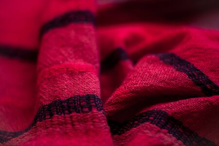 Red woolen fabric cloth background. Wavy texture purple materialの写真素材