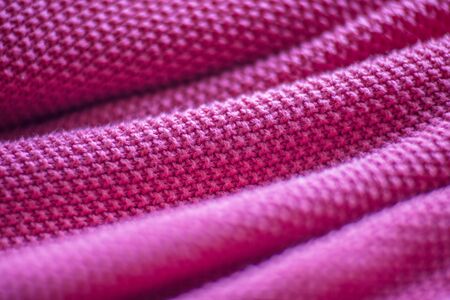 Pink woolen fabric cloth background. Wavy texture purple materialの写真素材