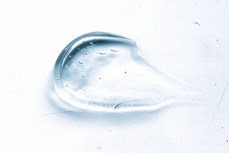 Transparent liquid gel cream smudge on white background. Blue cosmeticsの写真素材