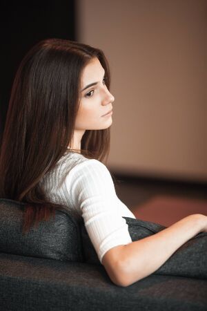 Young woman pretty relaxing on couch in living room. Casual style indoor shoot