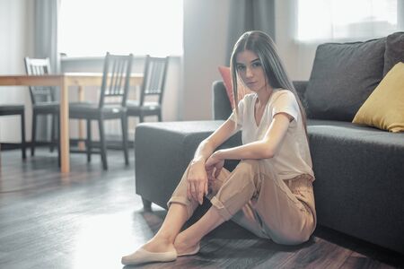 Young woman pretty relaxing on couch in living room. Casual style indoor shootの写真素材