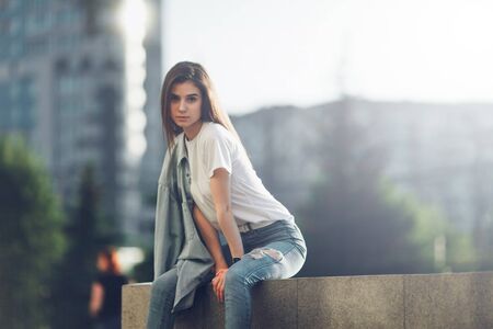 Fashion woman portrait of young pretty trendy girl. Sunny summer city street.の写真素材