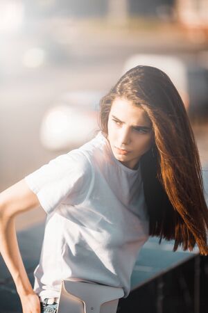 Summer sunny lifestyle fashion portrait. Young stylish hipster woman walking on the street. Summer wear style trendの写真素材