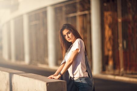 Hipster girl casual wear. Summer city portrait. Young tourist woman walks in townの写真素材
