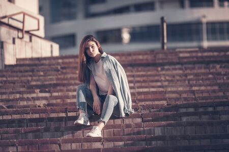 Beautiful tourist girl on city street. Gorgeous young model woman outdoor portrait. Fashionable wear.の写真素材