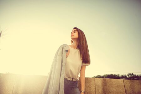 Hipster girl casual wear. Summer city portrait. Young tourist woman walks in townの写真素材