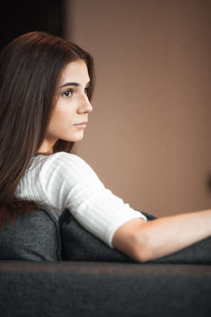 Young woman pretty relaxing on couch in living room. Casual style indoor shootの写真素材