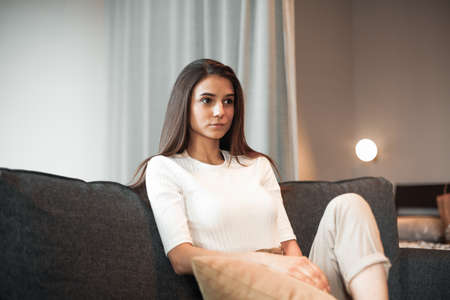 Young woman pretty relaxing on couch in living room. Casual style indoor shootの写真素材
