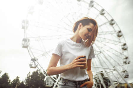 Fashion hipster cool girl relaxing on city street. Pensive female hipster model. Summer sunkight portraitの写真素材