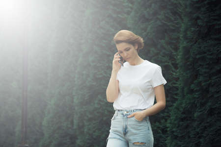 Fashion hipster cool girl relaxing on city street. Pensive female hipster model. Summer sunkight portraitの写真素材