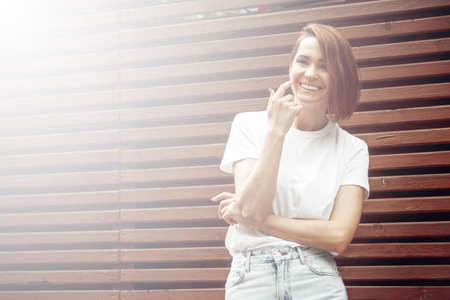 City portrait of a fashionable beautiful young girl. Outdoor relaxing trendy woman model