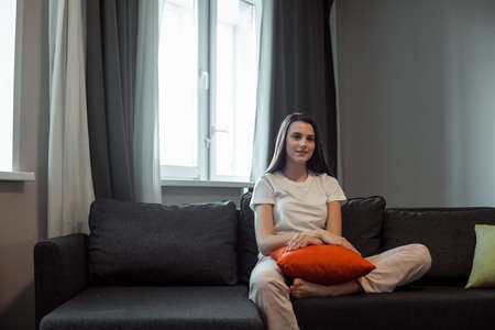 Young woman pretty relaxing on couch in living room. Casual style indoor shoot