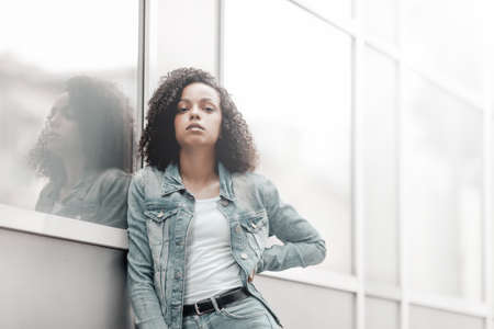 Black young pretty girl relaxing outdoor. Street hipster portrait. Walking student womanの写真素材