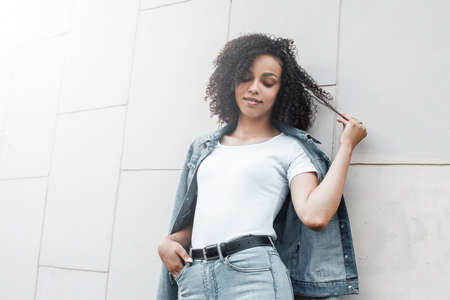 Black young pretty girl relaxing outdoor. Street hipster portrait. Walking student woman