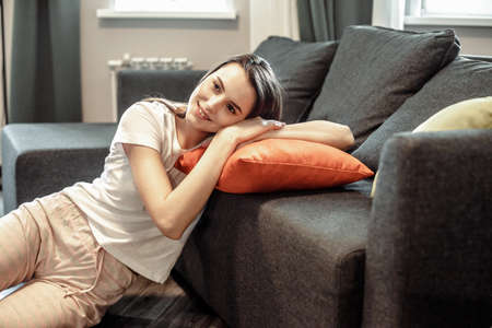 Young woman pretty relaxing on couch in living room. Casual style indoor shootの写真素材
