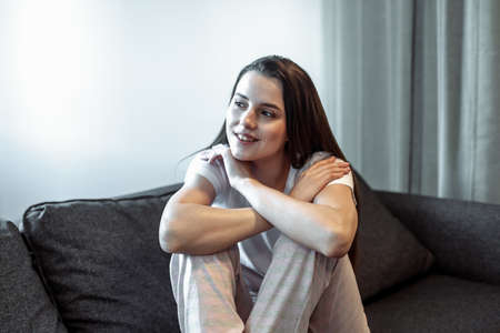 Young woman pretty relaxing on couch in living room. Casual style indoor shootの写真素材