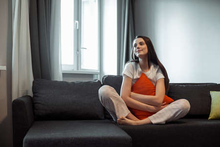 Young woman pretty relaxing on couch in living room. Casual style indoor shootの写真素材