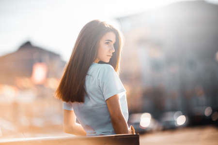 Hipster girl casual wear. Summer city portrait. Young tourist woman walks in town