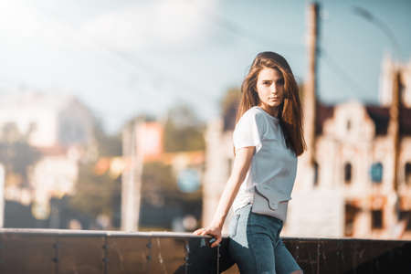 Beautiful tourist girl on city street. Gorgeous young model woman outdoor portrait. Fashionable wear.の写真素材