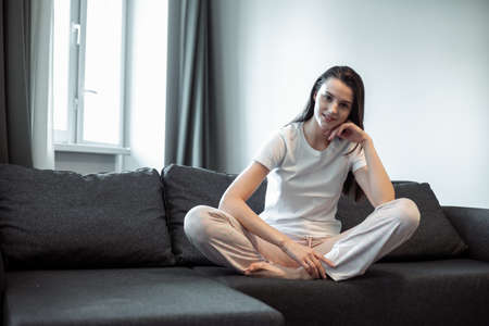 Young woman pretty relaxing on couch in living room. Casual style indoor shootの写真素材