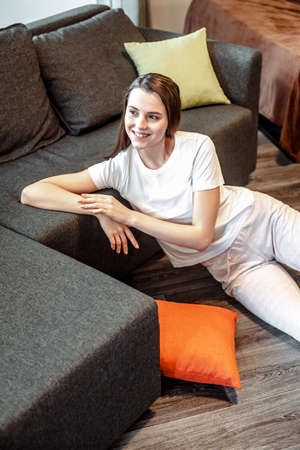 Young woman pretty relaxing on couch in living room. Casual style indoor shootの写真素材