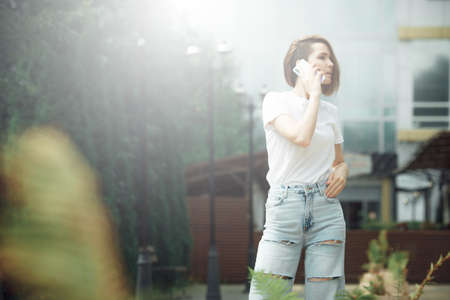 Hipster girl casual wear. Summer city portrait. Young tourist woman walks in town