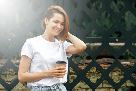 Fashion woman portrait of young pretty trendy girl. Sunny summer city street.の写真素材