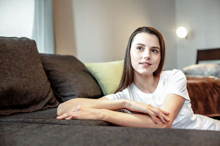 Young woman pretty relaxing on couch in living room. Casual style indoor shootの写真素材