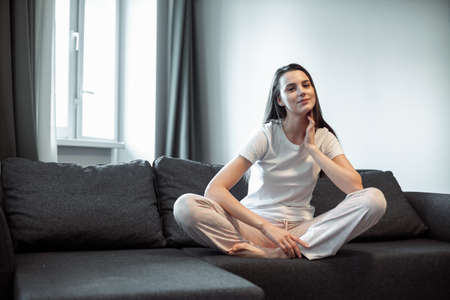Young woman pretty relaxing on couch in living room. Casual style indoor shootの写真素材